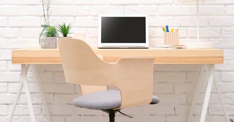 Home office with desk, chair, computer, and plant