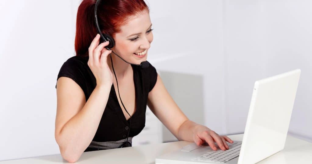 Woman working from home on a laptop and headset